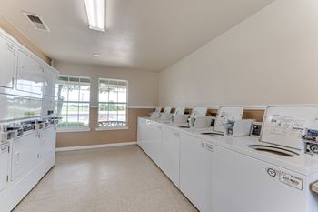 A laundry room with washers and dryers.